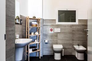 a bathroom with a sink and a toilet and a mirror at TRAVEL STATION Bedandbreakfast in Bari