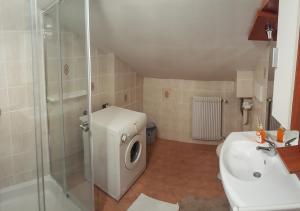 a bathroom with a shower and a toilet and a sink at Rooms with shared kitchen Zver, great for hikers in Hudajužna
