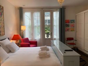 a hotel room with a bed with towels on it at The Old Lady in Amsterdam