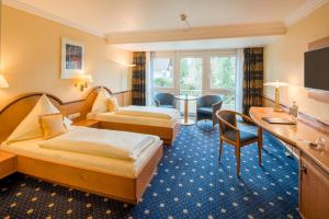 TV a/nebo společenská místnost v ubytování Hotel Asemann Planegg