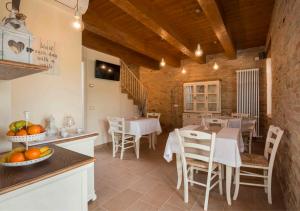 a kitchen and dining room with a table and chairs at B&B Olmo in Saludecio