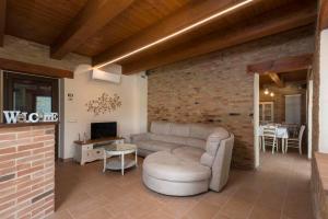 a living room with a couch and a tv at B&B Olmo in Saludecio