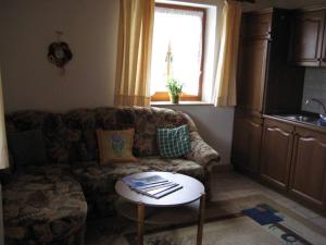 a living room with a couch and a table at Ferienwohnungen Haberberger in Pottenstein