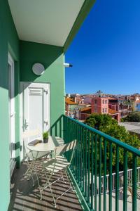 a patio with a table and chairs on a balcony at In2Lisbon - Kionga Suites in Lisbon