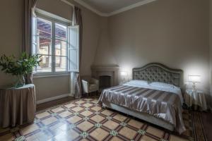 Postel nebo postele na pokoji v ubytování Hotel Torre Guelfa Palazzo Acciaiuoli