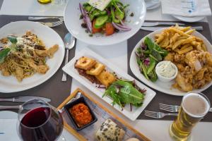 a table with several plates of food on it at Island Boutique Hotel in Larnaca