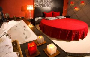 a bathroom with a bed and a tub with candles at Surmeli Istanbul Hotel in Istanbul