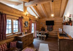 a kitchen with wooden walls and wooden floors at Ferienhof Ellerbeck in Langdorf