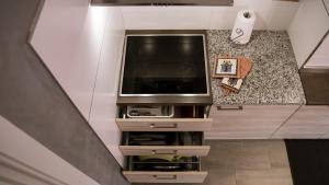 a tv sitting on a stand in a living room at Casa Guetti Terme di Comano in Comano Terme
