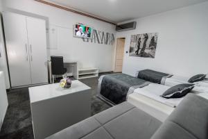 a living room with two beds and a couch at Hotel Cool Zagreb Airport in Velika Gorica