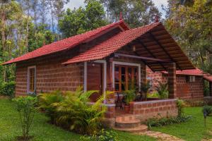 a small brick house with a red roof at The Copper Edge in Kodlipet