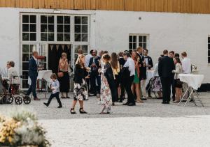 a bride and groom walking down the aisle at their wedding at Elisefarm in Fogdarp