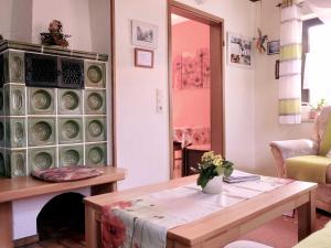 a living room with a table and a fireplace at Ferienhaus Trautner in Muggendorf