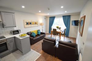 a living room with a couch and a dining room at Benbulben Court in Sligo