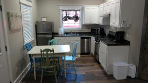 a kitchen with white cabinets and a table and chairs at Wildflower Bed and Breakfast in Mountain View