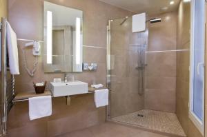 a bathroom with a shower and a sink and a shower at Hotel de L'Empereur by Malone in Paris