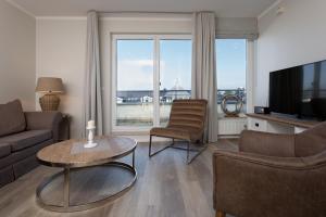 TV a/nebo společenská místnost v ubytování strandnahe FeWos mit Balkon, Residenz Bel Vital - Kategorie B