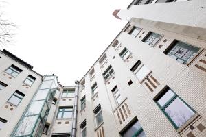 un edificio alto con muchas ventanas en una ciudad en Apartment GREIF - Cozy Family & Business Flair welcomes you - Rockchair Apartments en Berlín