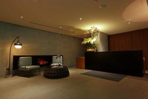 a living room with a fireplace and a large screen at Water House in Taipei