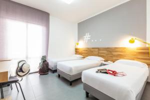 Ibis Styles Brindisi客房内的一张或多张床位