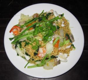 a white plate of food with noodles and vegetables at Thanh Cong Hotel in Sa Ðéc
