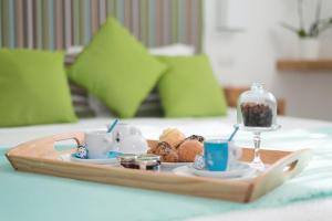 a tray of coffee and pastries on a table at Sorrento Stylish Rooms in Sorrento