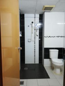 a bathroom with a toilet and a shower at Hotel Damai in Parit Buntar