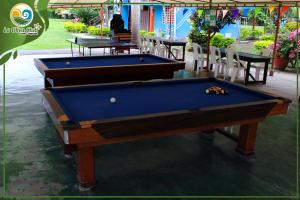 two pool tables sitting on a patio next to a table at La Oliva Club Centro Campestre in La Gorgona