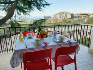 a table with fruit on top of a balcony at Cabà Holiday Bardolino Santa Cristina in Bardolino