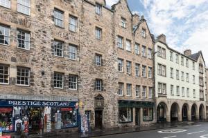 a large brick building on the side of a street at Sunny & spacious Royal Mile apt dating from 1677 in Edinburgh