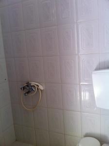 a bathroom with a shower head on a wall at Porto Milos in Adamantas
