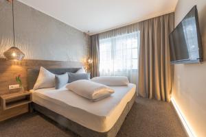 Ένα ή περισσότερα κρεβάτια σε δωμάτιο στο LakeSide Apartments Seefeld