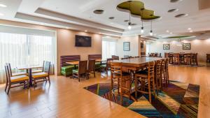 a dining room table and chairs in a large room at Best Western Plus North Shore Hotel in Danvers