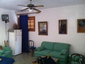 a living room with a green couch and a refrigerator at Porto Milos in Adamantas +15 photos