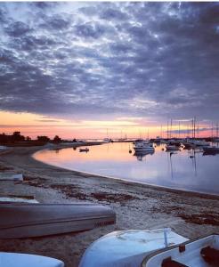 een groep boten in het water bij zonsondergang bij The Attleboro House in Oak Bluffs