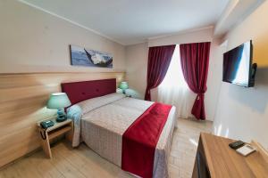 Un pat sau paturi într-o cameră la Hotel Balilla