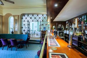 a bar in a restaurant with purple chairs and tables at The Hotel Balmoral - Just for Adults in Torquay +75 photos