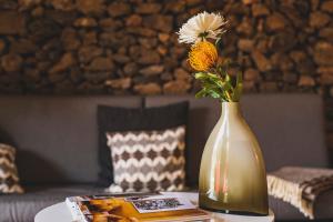 a vase with a flower in it on a table at Finca Malvasia Vineyard in Tías