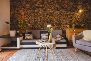 a living room with a couch and a table at Finca Malvasia Vineyard in Tías