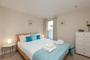 1 dormitorio con 1 cama con toallas en Glasgow City Flats, en Glasgow