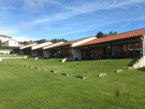 a row of buildings with a grass yard in front at Le Domaine De Fonteline in Allègre