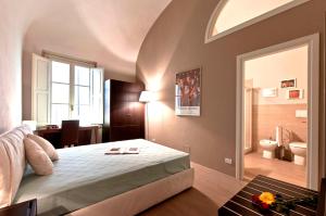 een slaapkamer met een groot bed en een badkamer bij New Galileo in Pisa