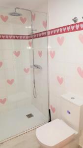 a bathroom with a shower with pink hearts on the wall at La Casa de Mencía AT-47-44 in Valladolid