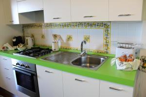 a kitchen with a sink and a stove at Villa Sofia in Taormina