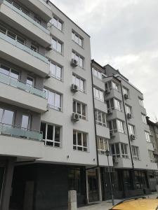 a white building with windows on a street at Hotel39 in Plovdiv