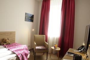 a hotel room with a bed and a teddy bear at Hotel Edel Weiss in Bremen