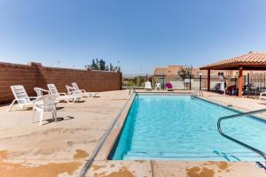 a swimming pool with chairs and a gazebo at Rim Vista 9A8 in Moab