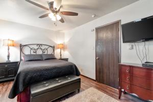 a bedroom with a bed and a ceiling fan at Redwood Commons B12 in Angel Fire