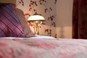 Postel nebo postele na pokoji v ubytování Amberley Inn