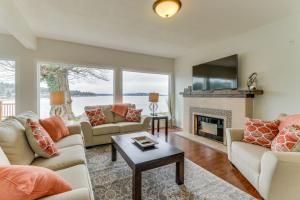 a living room with couches and a fireplace at Bay Street Oasis in Port Orchard